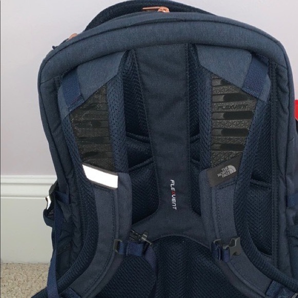 navy blue and rose gold north face backpack